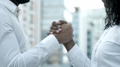 slow motion shot of people shaking hands on street