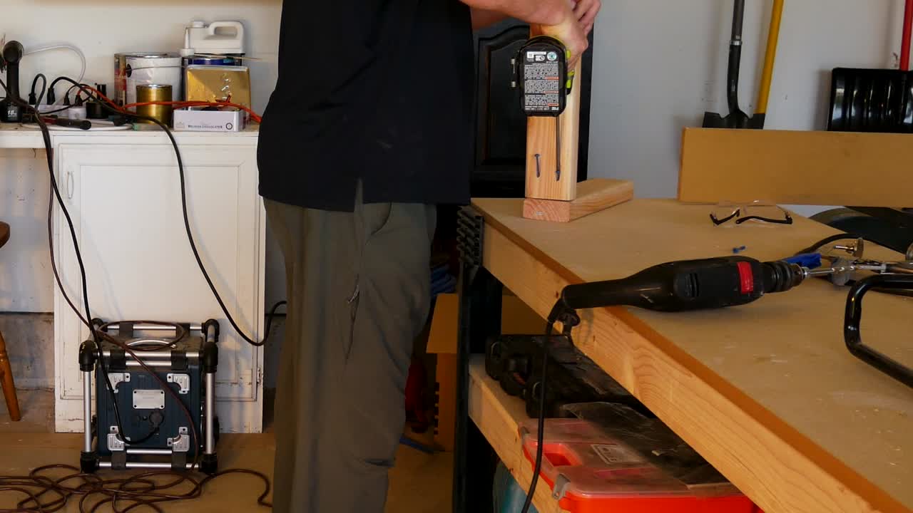 Man uses pocket hole screws to joing two boards together - CLOSE UP