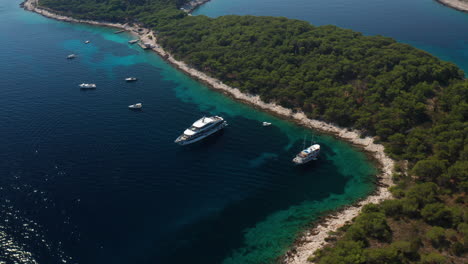 boats anchored at the shore of paklinski islands in croatia - aerial drone shot