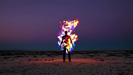 fire performer in the desert at dusk