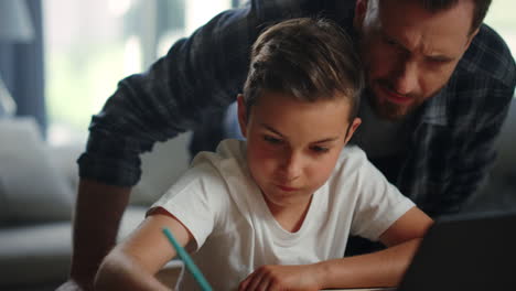 parent helping child doing homework