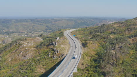 panoramic view of a freeway cutting nature