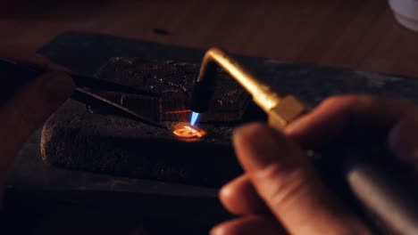 goldsmith crafting ring by burner