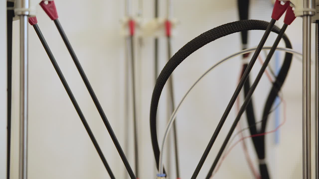 close up shot 3d printer parts axis wires moving left right daylight