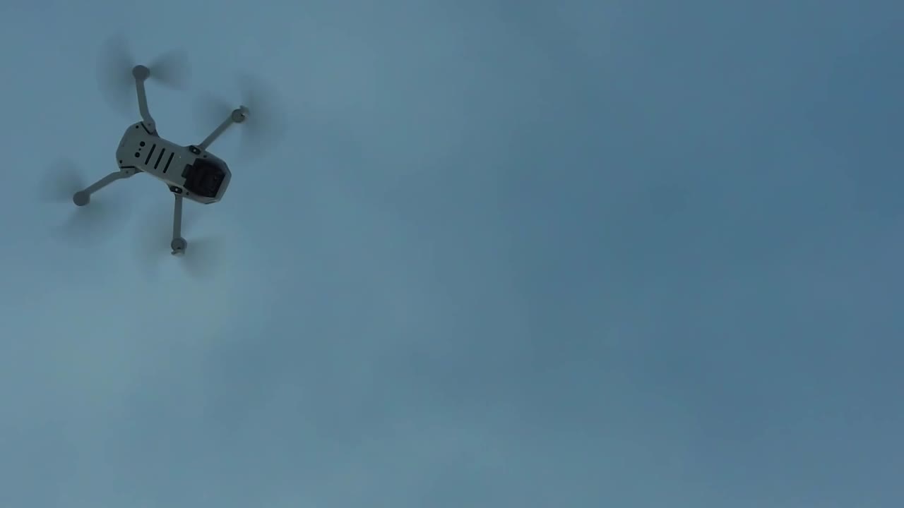 DJI drone flys above in-flight slomo pan 2