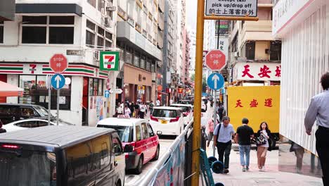 pedestrians and vehicles on a bustling city street