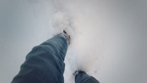 winter walk pov hiking scene with legs in high snow