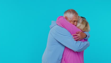 Romantic-senior-couple-grandfather-grandmother-hugging,-embracing,-looking-at-camera-and-smiling