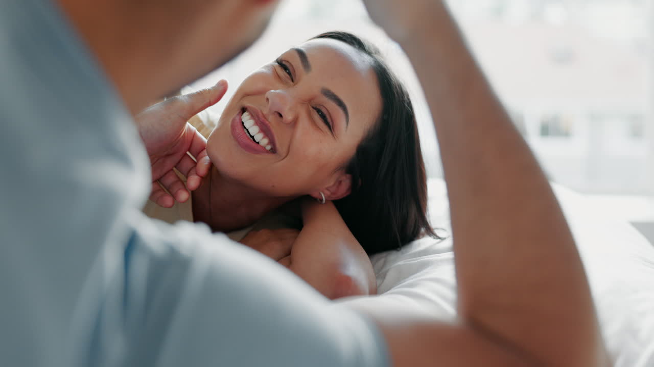 Couple, touch face and relax on bed with love