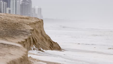 a 10-second video showing coastal erosion at broadbeach, highlighting the impact of seafoam and erosion on the pacific ocean shoreline