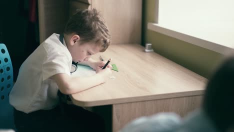 stedicam children sit in headphones and do school homework