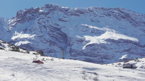 Two-snow-trucks-climbing-uphill-in-the-Fannes-Sennes-Park,-South-Tyrol