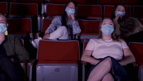 people watching a movie in a theater during the pandemic