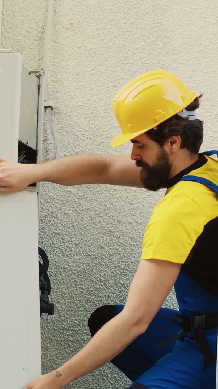Vertical video Wireman dissasembling air conditioner