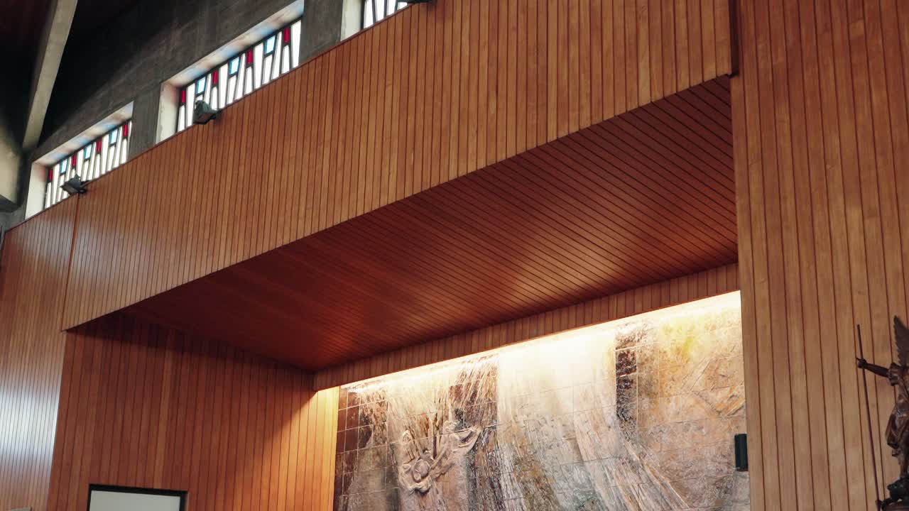 interior detail of church wall with wood paneling and stained glass windows