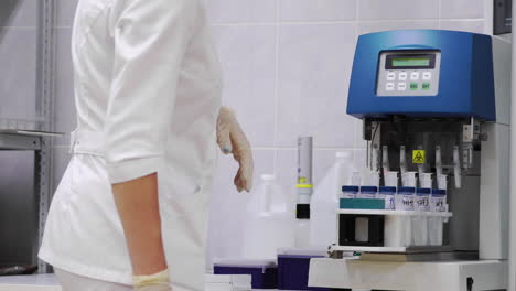 Girl sets samples women&#039;s gynecological fluid for analysis on cancer, automated studies