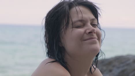 Adult-Female-Caucasian-Smiling-Facing-The-Camera-At-The-Beach---Closeup-Shot