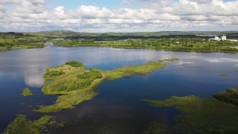 panoramic aerial footage over river and green hills during high tide, the gearagh protected nature in county cork, ireland