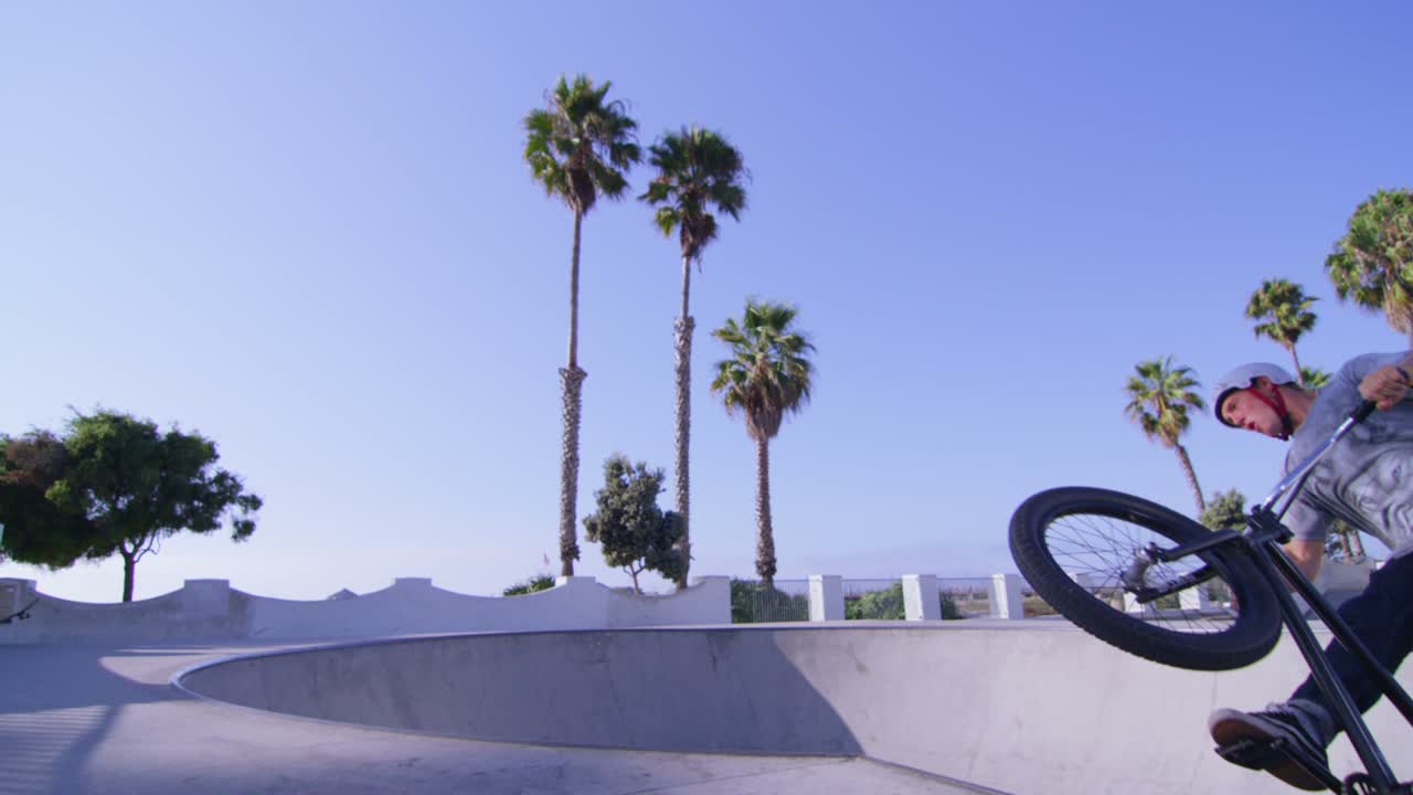 bmx 자전거 라이더는 점프를 하고 스케이트파크에서 벽을 탄다