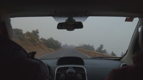 driving on highland road with cloud mist