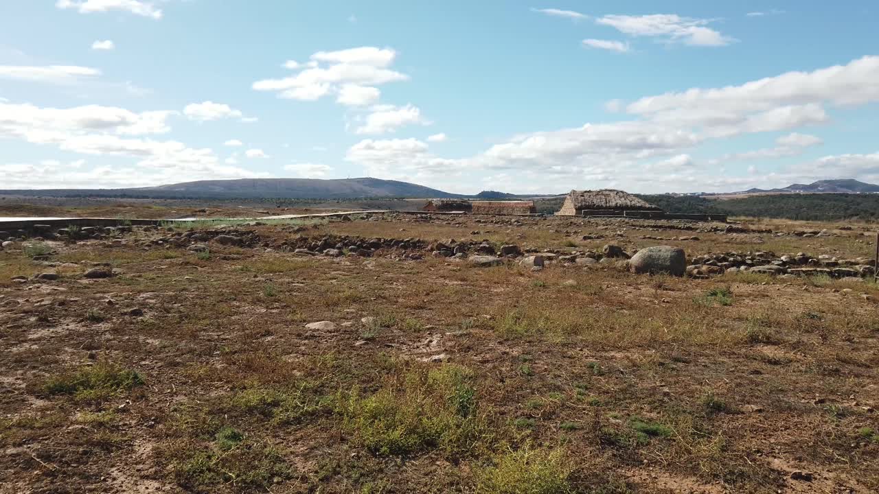 Roman ruins at Yacimiento archaeological site in Garray Spain. with Spanish flag