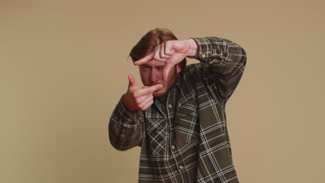 photographer man gesturing picture frame with hands imitating zoom and cropping nice image photo