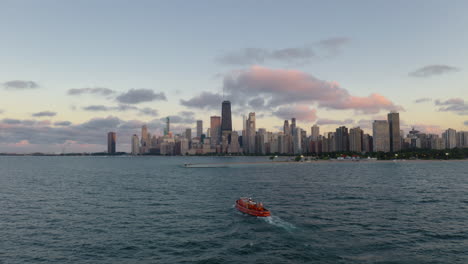 aerial view of downtown chicago with a red boat on lake michigan