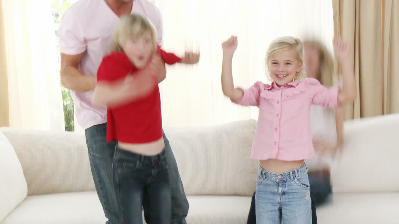 Family celebrating a success in a football match at home