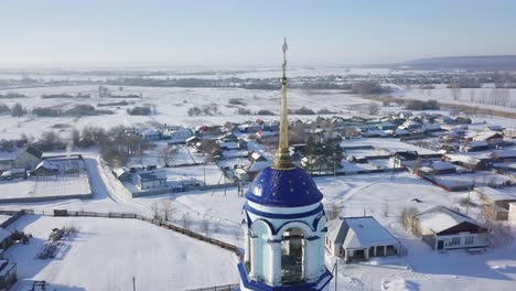 snowy village with church tower