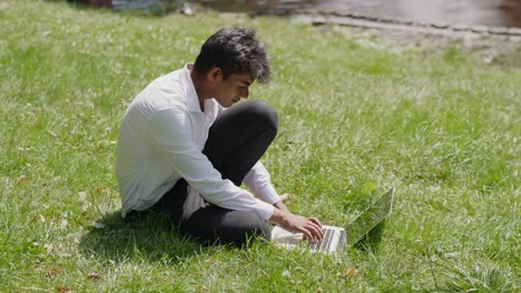 entrepreneur working on green grass in park on