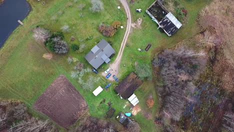 slow descending shot of family home with lots of cars in the yard - family gathering for holidays