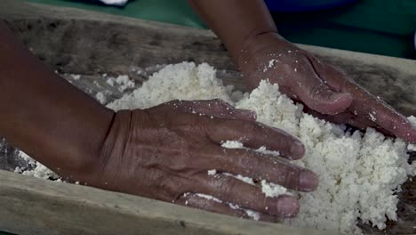 Costa-Rican-indigenous-woman-kneading-fresh-curds-for-forming-traditional-cheese,-Close-up-handheld-shot