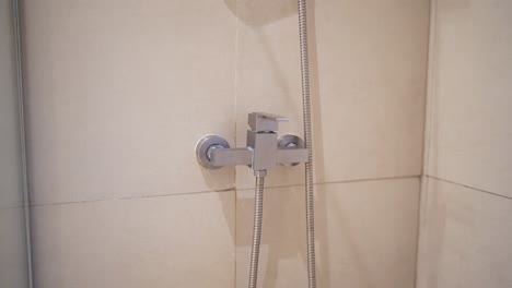 close up of a modern shower fixture in a hotel bathroom, showcasing minimalist design and clean lines, reflecting a contemporary and sophisticated style