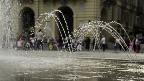 Ground-level-fountain-in-Italy-in-slow-motion-scene-pan-right