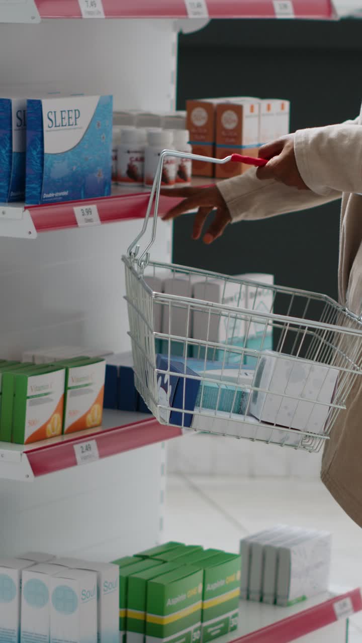 Vertical video: Young adult looking at medical products and medication on shelves