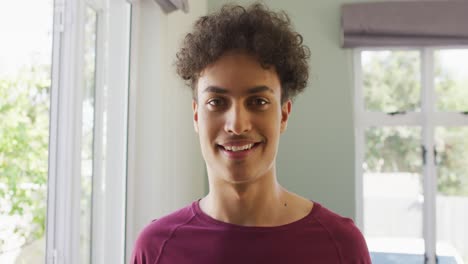 portrait of happy biracial man smiling in living room