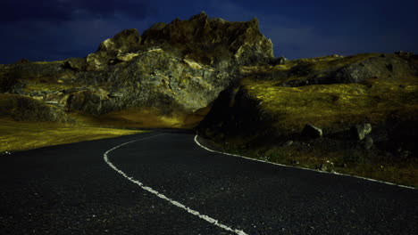 winding road through rocky terrain under night sky with soft lighting