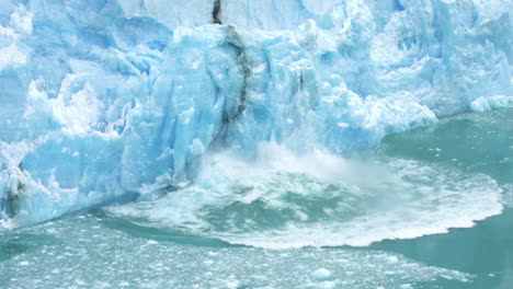 glacier ice collapse into ocean water, close up