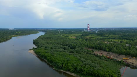 aerial view of vistula river in poland and coal power plant in background