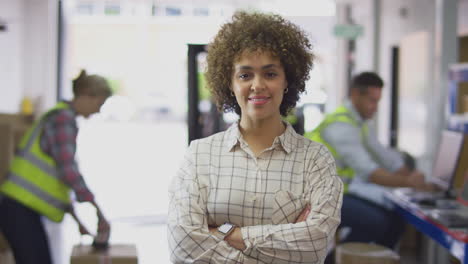 Portrait-Of-Smiling-Female-Manager-In-Logistics-Distribution-Warehouse