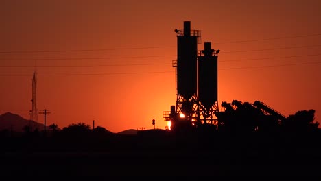 Beautiful-time-lapse-sunrise-behind-farm-or-factory-in-the-countryside