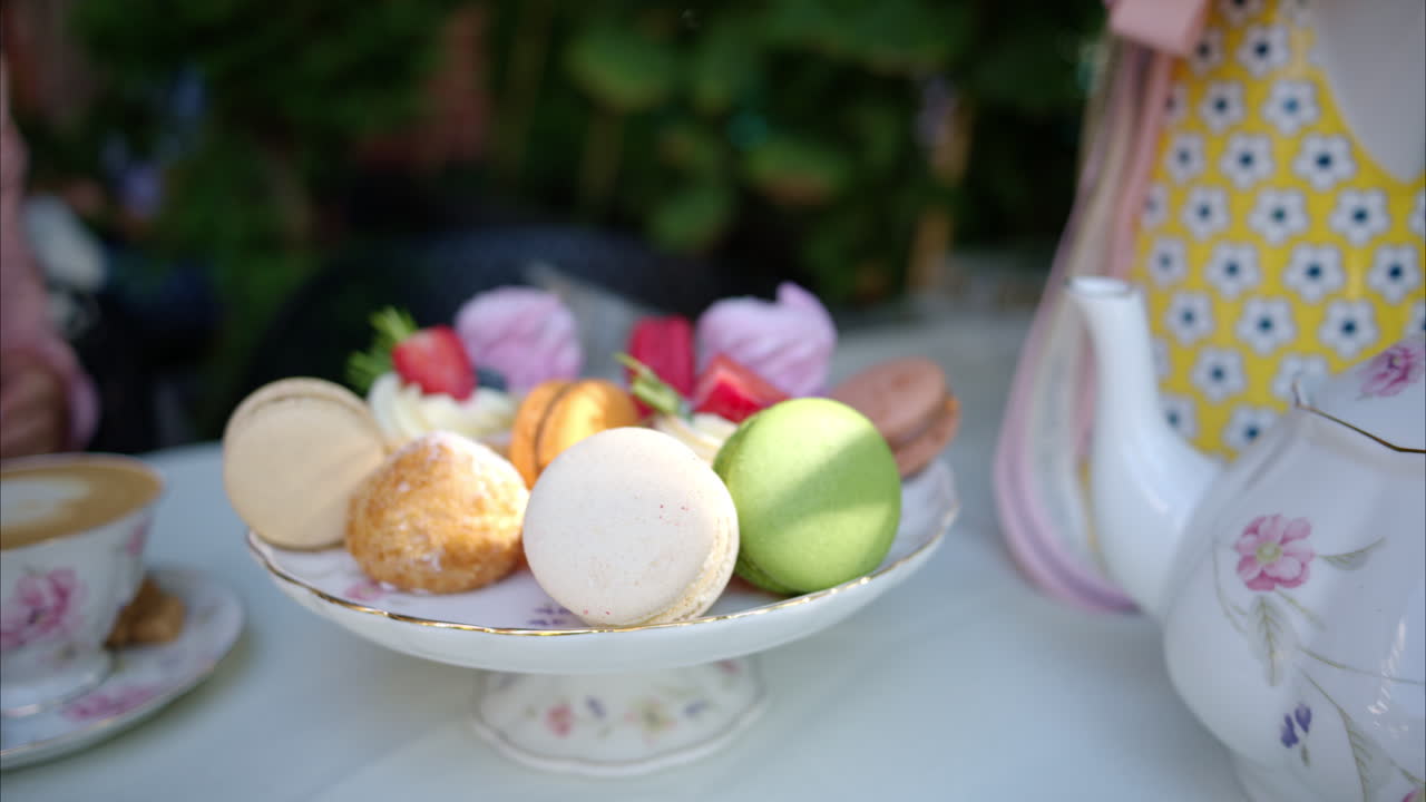 Composition with flowers, macaroons sweets desert and coffee and tea