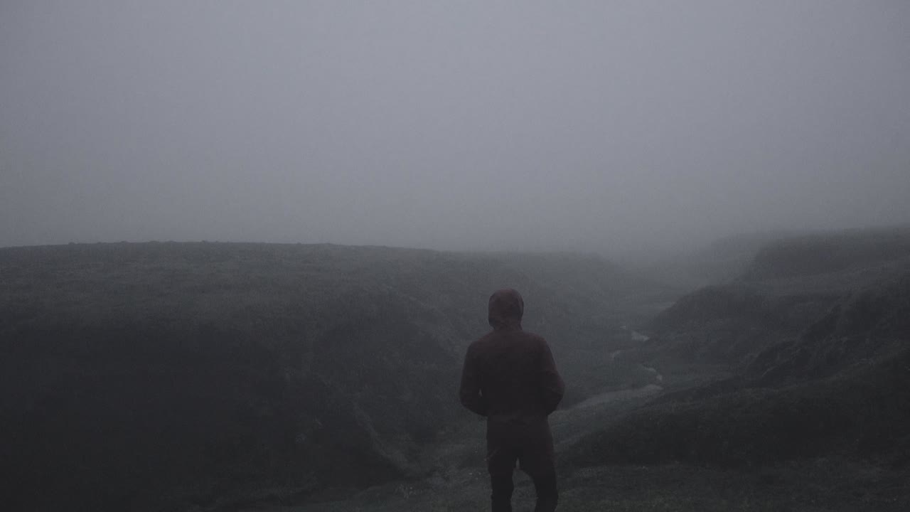silueta en un cañón islandés abandonado en un paisaje brumoso, cambiante y dramático