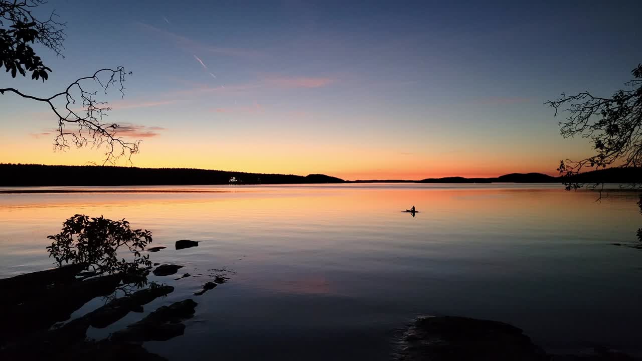 A Tourist Paddles on the Sunset Ocean with a Stunning Scenic View of the Colorful Twilight - Dusk Golden Hour on the Pacific Northwest Coast of Canada