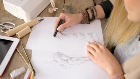 crop shot of dressmaker drawing sketches