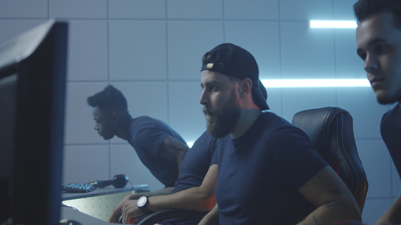 Gaming Team Sitting down at Computers Medium Closeup of a Team Sitting down at their Computers at a Gaming Tournament