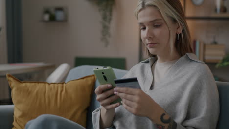 woman shopping online using her smartphone and credit card
