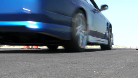 a blue car revs its engine before taking off at a drifting course in camarillo california