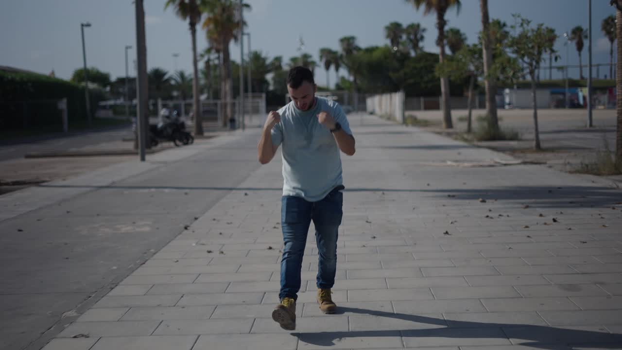 Man walking and celebrating on a city street