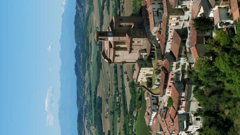 aerial view of parish church clock tower on hillside at ozzano monferrato, italy